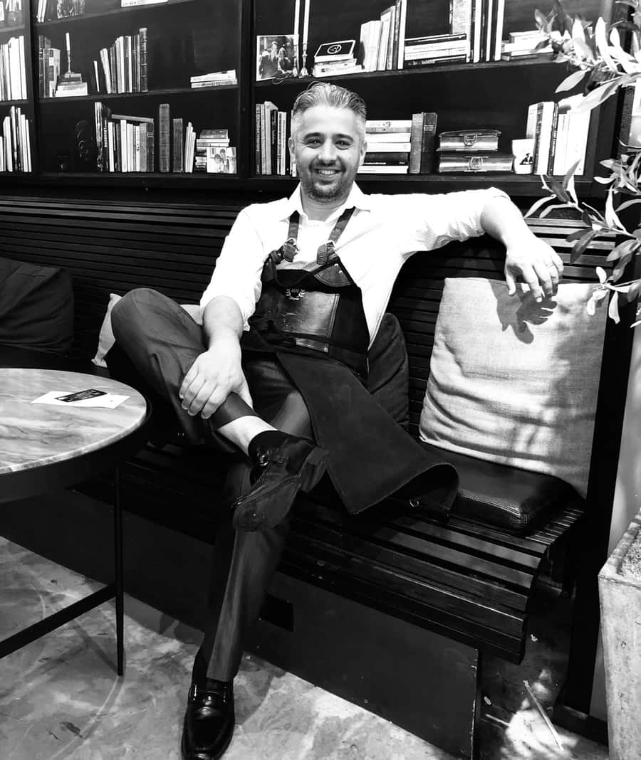 Barber sitting at a bench