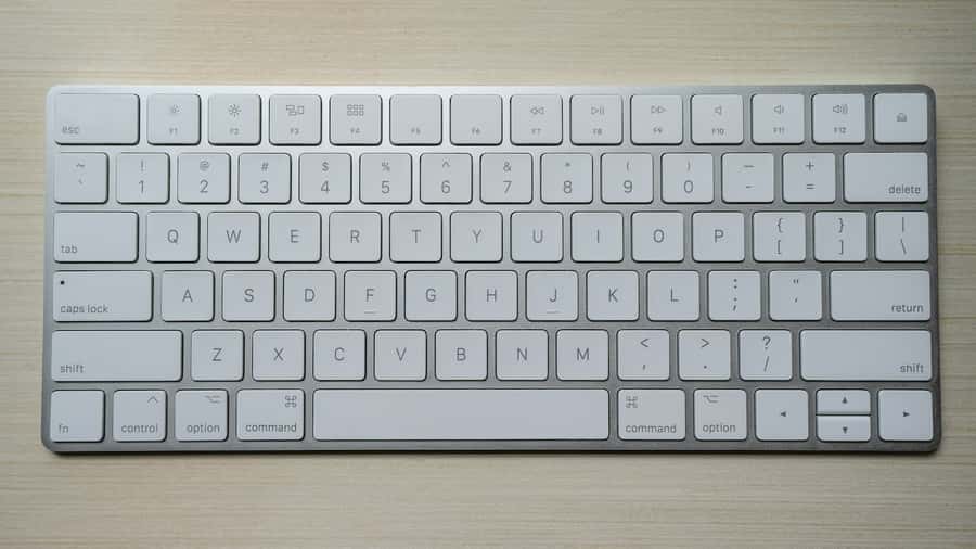 Bright white computer keyboard on a yellow background