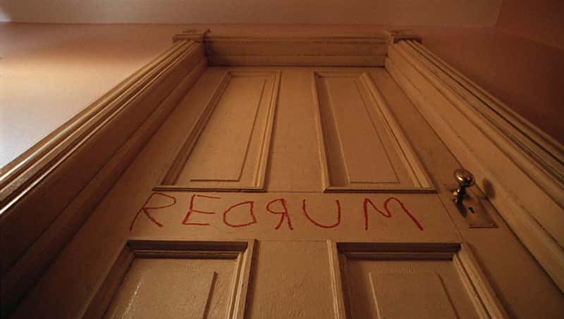 The image shows the interior of a door with the word "Redrum" written on it in red text.